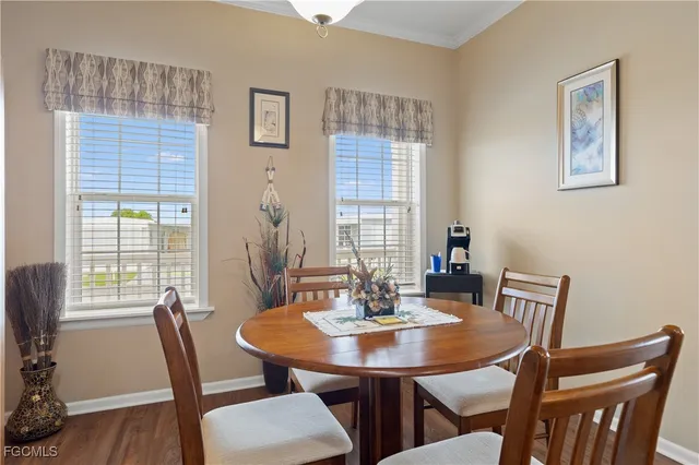 a view of a dining room with furniture window and wooden floor