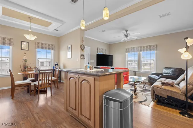 a living room with furniture a wooden floor and a window