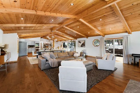 a living room with lots of furniture and kitchen view