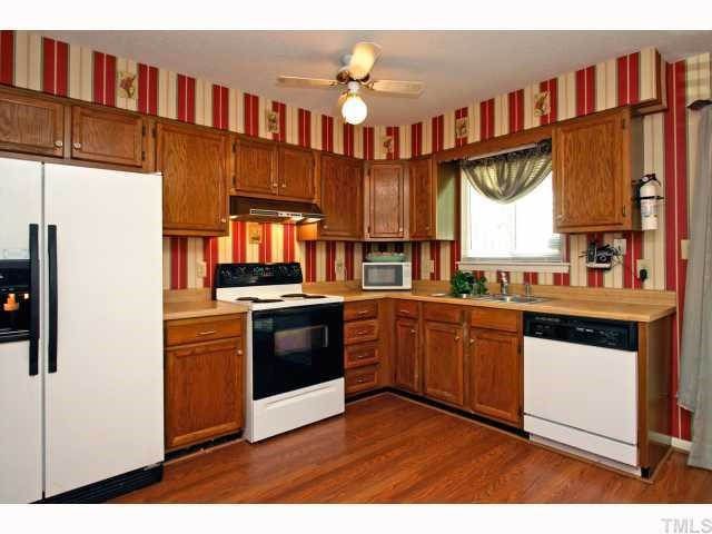 5827 Shady Grove Circle Raleigh, NC 27609 - Photo 5 of 11 Huge kitchen perfect for entertaining or for the chef at heart. Warm oak cabinets w/ updated hardware, double stainless sink, plenty of cabinet space, additional side window for even more light and (you can't see it) but a side open built-in bookshelf.