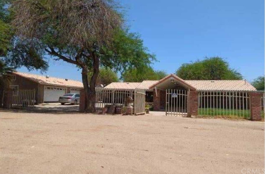 a front view of a house with a yard covered with snow