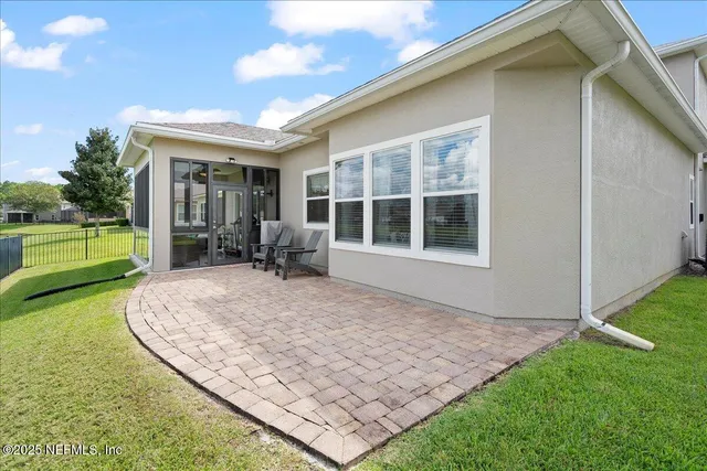 an aerial view of residential houses with outdoor space and lake view