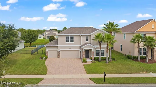 an aerial view of residential houses with outdoor space and a lake view
