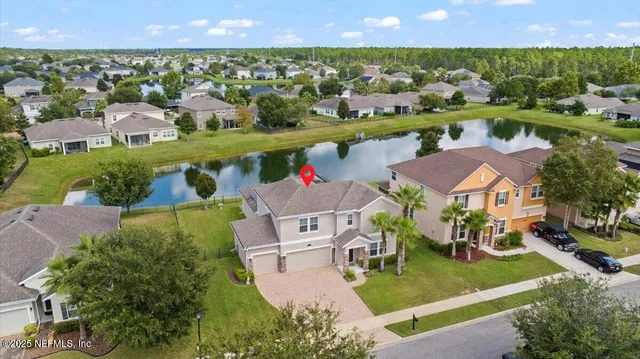 an aerial view of a house with a swimming pool