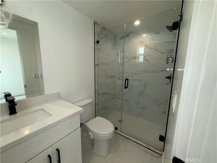 a kitchen with kitchen island a refrigerator a stove a microwave and wooden floor