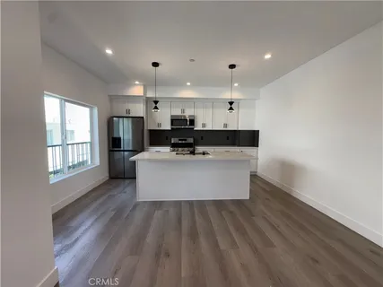 an empty room with wooden floor and a window