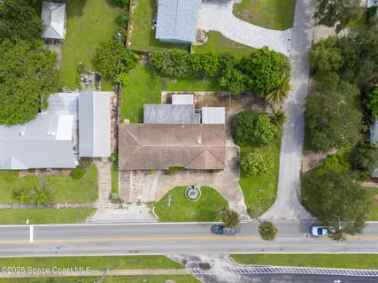 an aerial view of a house with a yard and potted plants