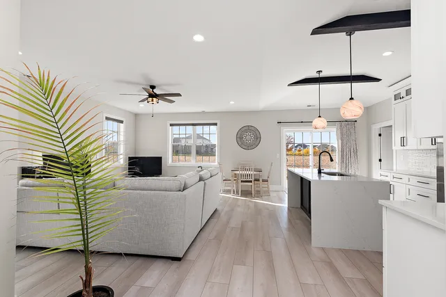 a living room with furniture and a chandelier