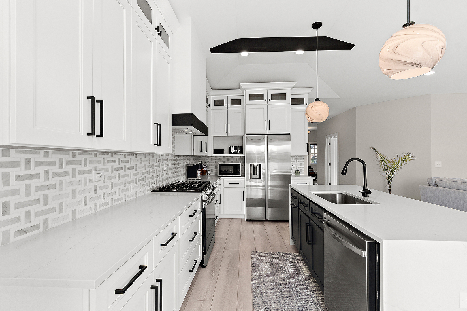 23960 Ann Court Manhattan, IL 60442 - Photo 3 of 31 a kitchen with stainless steel appliances a sink a stove and a wooden floors