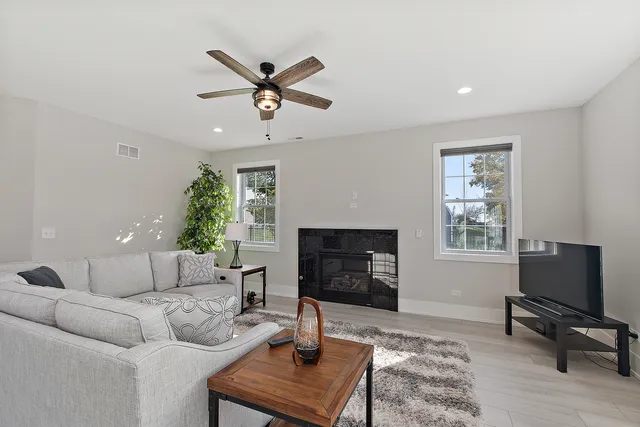 a living room with furniture a window and a fireplace