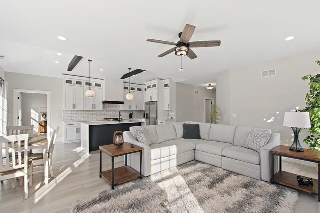 a living room with furniture and a wooden floor