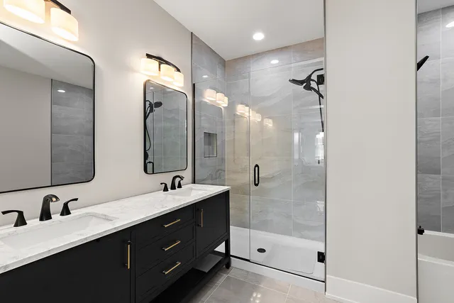 a bathroom with a double vanity sink mirror double and shower