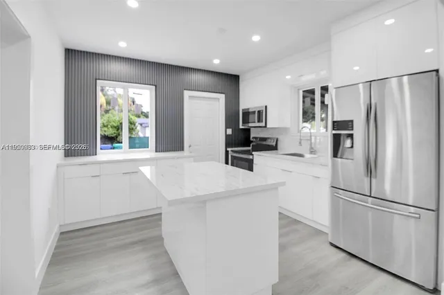 a kitchen with refrigerator and window