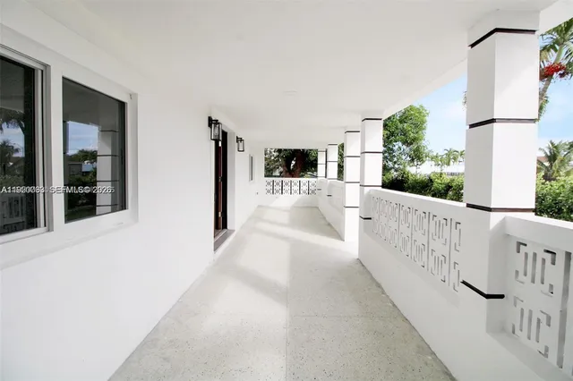 a view of a porch with wooden floor and fence