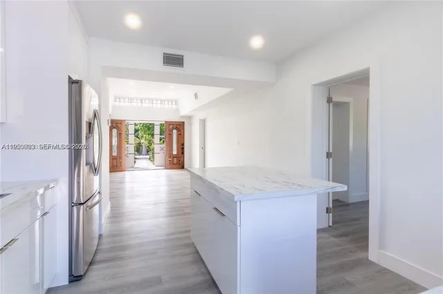 a view of a kitchen cabinets and wooden floor