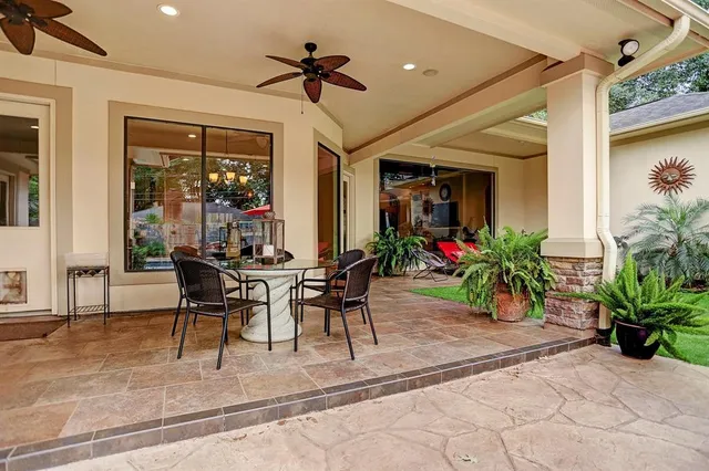 a view of a patio with table and chairs potted plants with wooden floor