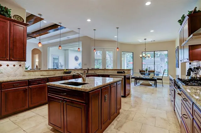 a kitchen with a sink stove and cabinets