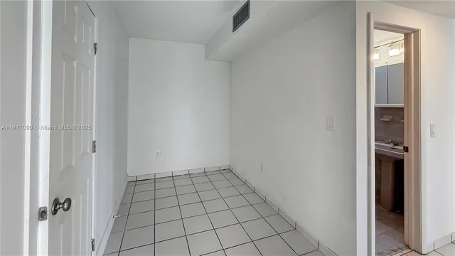 a view of an empty room and closet area