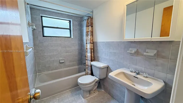 a bathroom with a toilet sink and shower