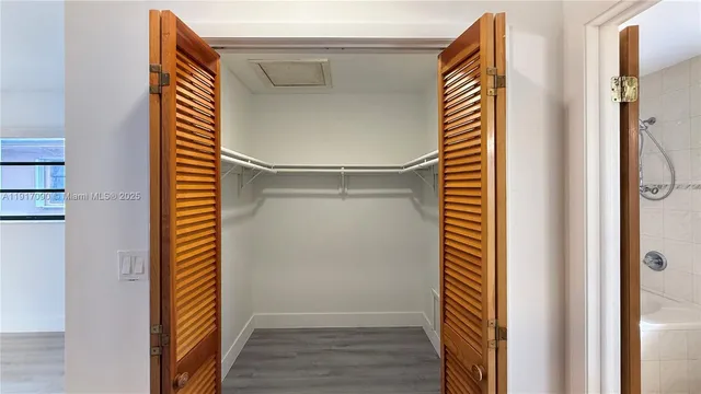 a view of bathroom with shower and wooden floor