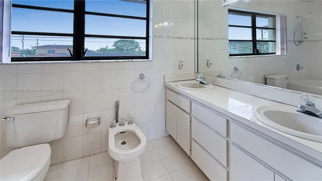 a bathroom with a toilet a sink and bathtub