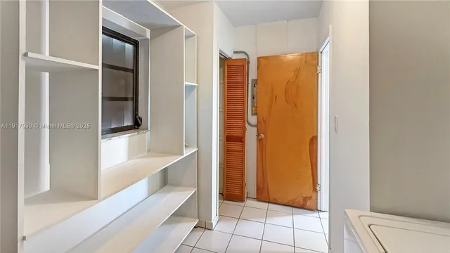 a view of a deck with a floor to ceiling window and wooden fence