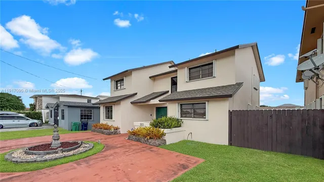 a front view of a house with a yard table and chairs