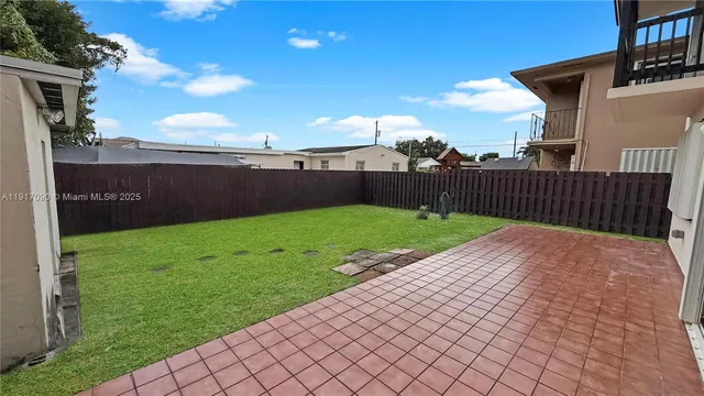 a view of a backyard of the house