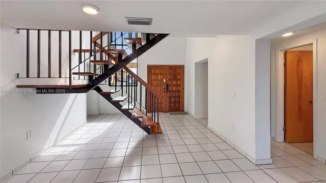 a view of an entryway with wooden floor