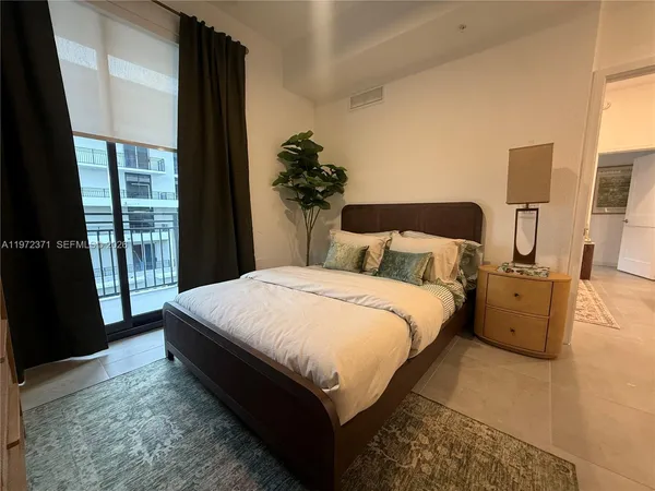 a bed sitting in a bedroom next to a window