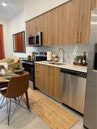 a kitchen with a sink cabinets and wooden floor