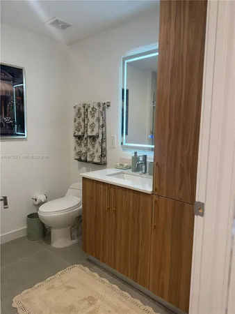 a bathroom with a toilet a sink and mirror