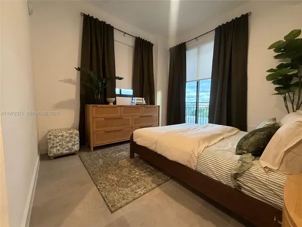 a bedroom with a bed and a potted plant