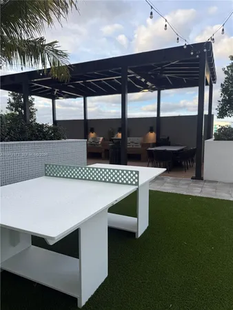 a view of a terrace with a table and chairs
