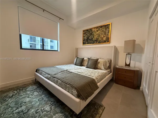 a bedroom with a bed and wall painting