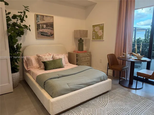 a bedroom with a bed and a potted plant