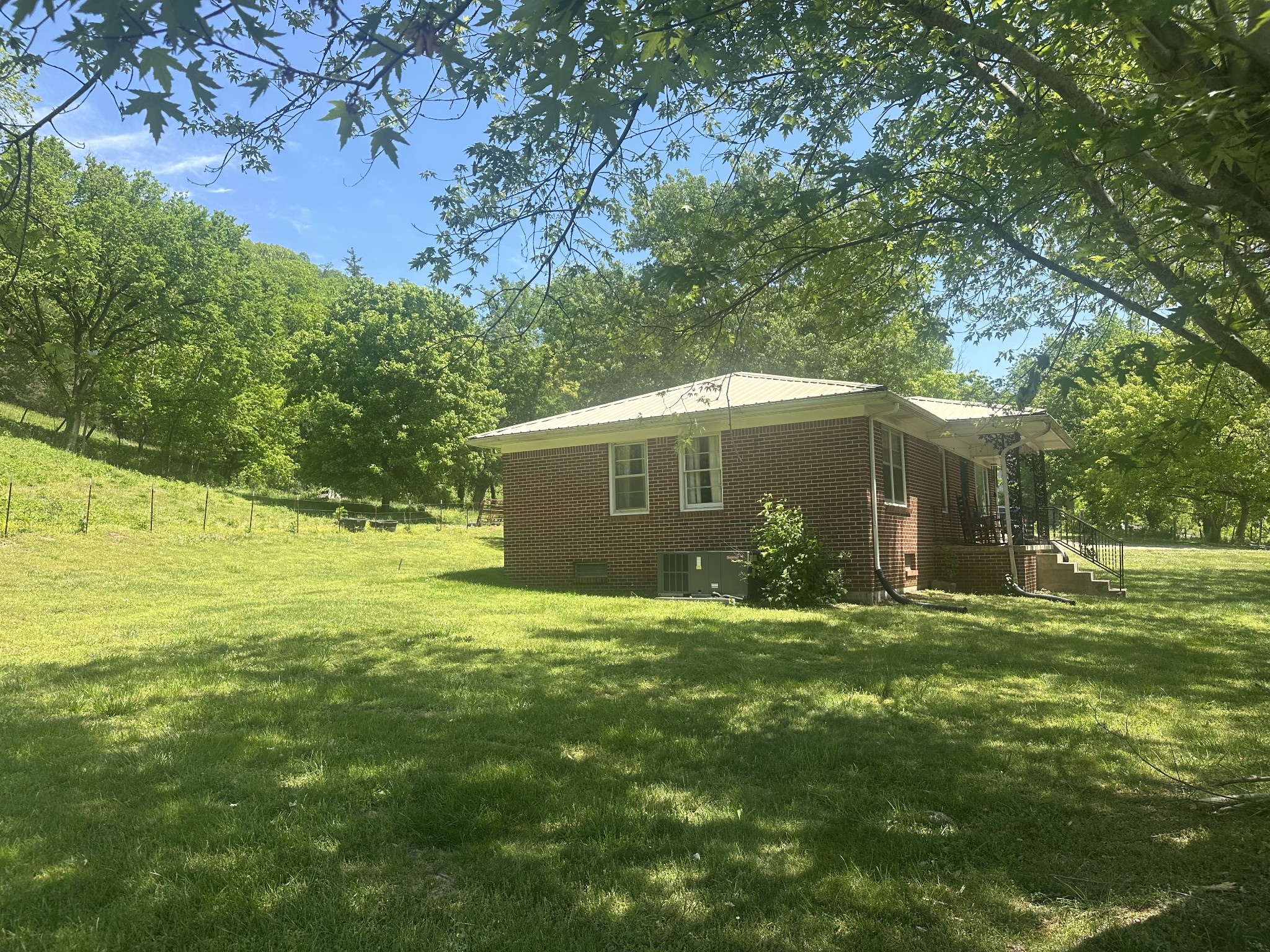 202 Maggart Road Elmwood, TN 38560 - Photo 12 of 34 a backyard of a house with large trees and plants
