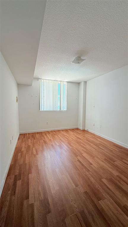 601 Northeast 23rd Street, Unit 902 Miami, FL 33137 - Photo 16 of 49 a view of empty room with wooden floor and fan