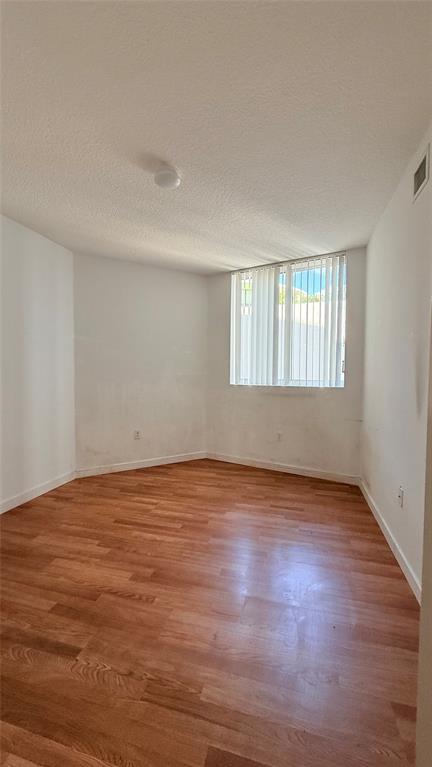 601 Northeast 23rd Street, Unit 902 Miami, FL 33137 - Photo 22 of 49 a view of an empty room with wooden floor and window