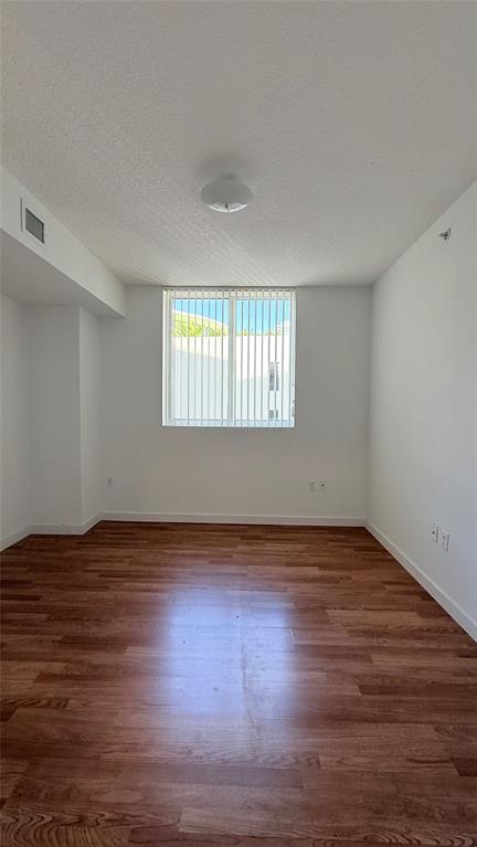601 Northeast 23rd Street, Unit 902 Miami, FL 33137 - Photo 29 of 49 a view of an empty room with wooden floor and window