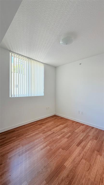 601 Northeast 23rd Street, Unit 902 Miami, FL 33137 - Photo 30 of 49 a view of an empty room with wooden floor and a window