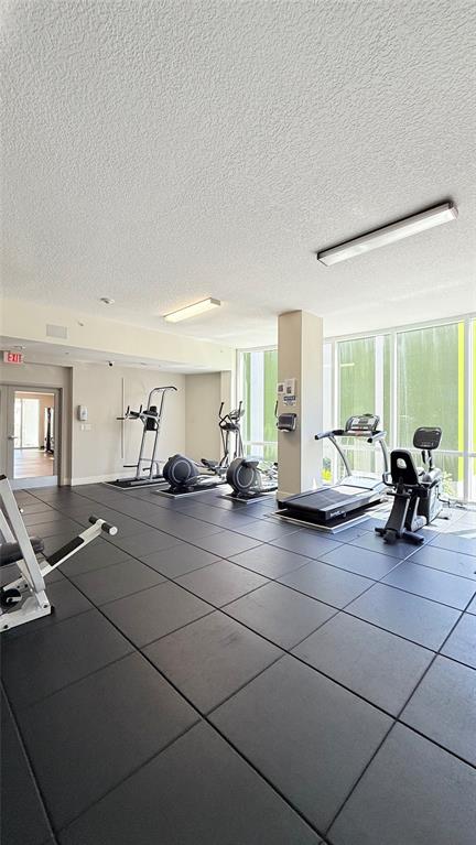 601 Northeast 23rd Street, Unit 902 Miami, FL 33137 - Photo 41 of 49 a view of living room filled with furniture and gym equipment