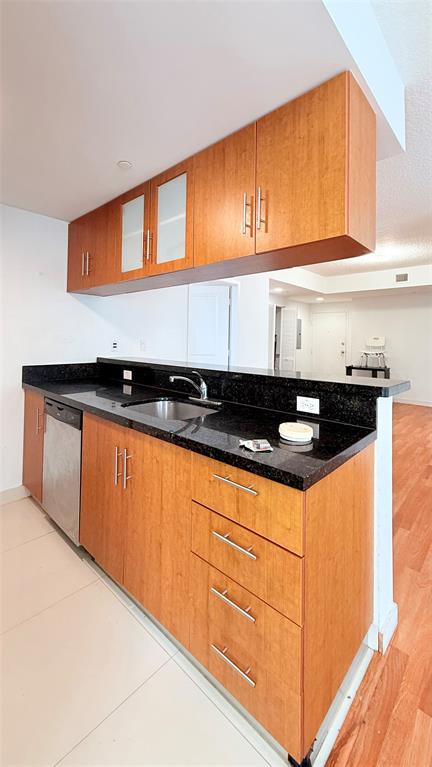 601 Northeast 23rd Street, Unit 902 Miami, FL 33137 - Photo 8 of 49 a kitchen with granite countertop a sink and cabinets