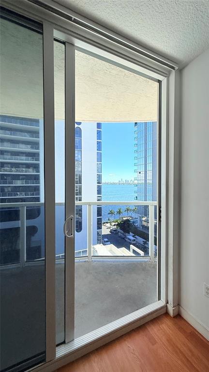 601 Northeast 23rd Street, Unit 902 Miami, FL 33137 - Photo 10 of 49 a view of a room that has a large window and a wooden floor