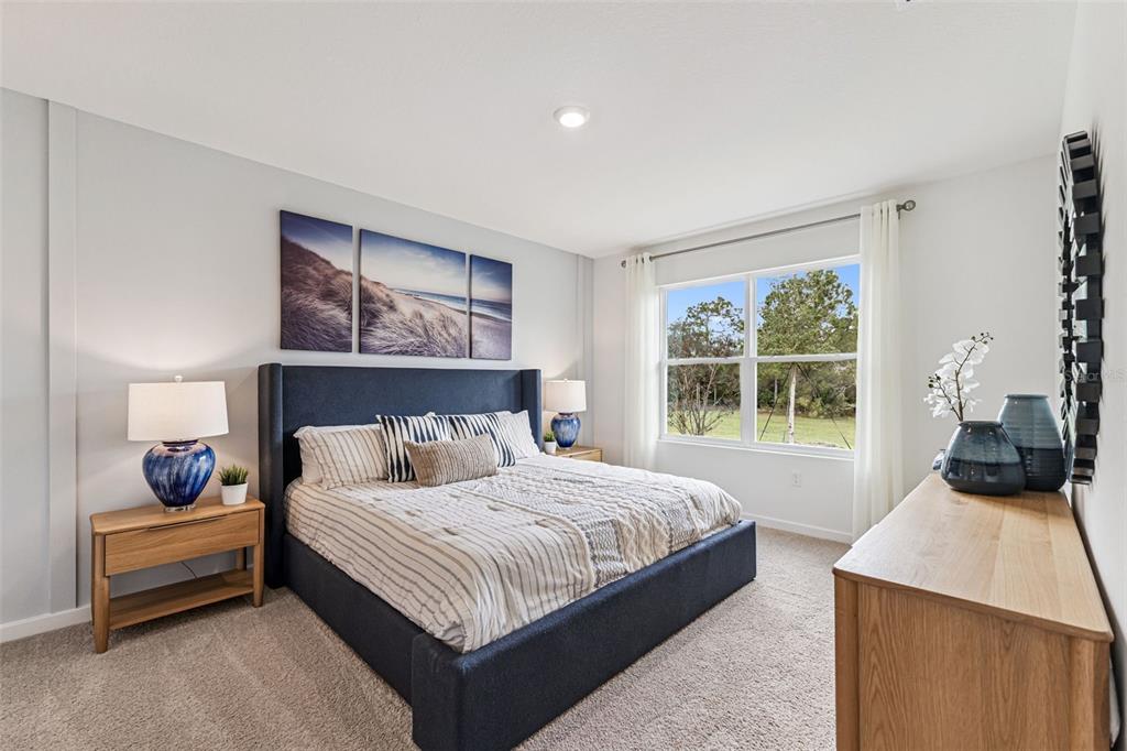 2827 House Finch Road St. Cloud, FL 34773 - Photo 21 of 70 a bedroom with a bed and a window