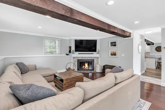 a living room with furniture a fireplace and a flat screen tv