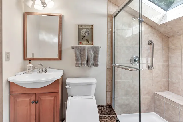 a bathroom with a sink toilet and shower