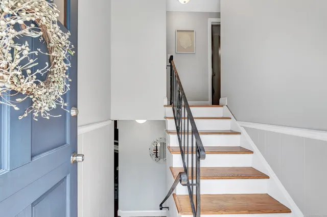 a view of staircase with white walls and railing