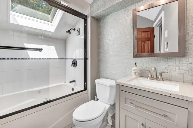 a white toilet sitting next to a bathroom sink