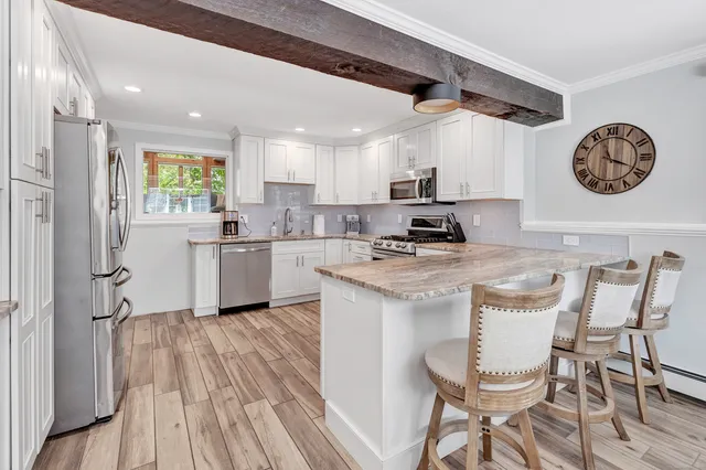 a kitchen with a sink cabinets and wooden floor